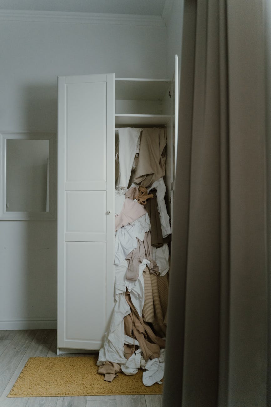photo of an untidy and messy white wooden closet