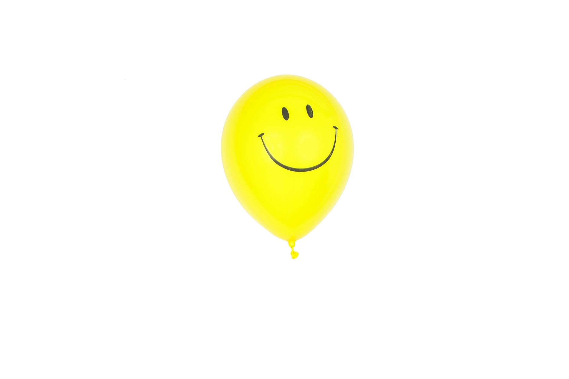 yellow smiley balloon with white background